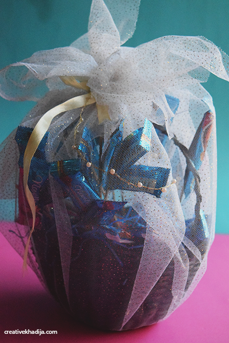 How to decorate and wrap a chocolate filled gift basket 